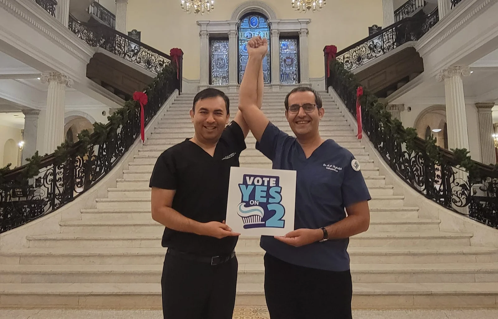Dr. Mouhab Rizkallah at the Massachusetts State House with a Yes on 2 sign